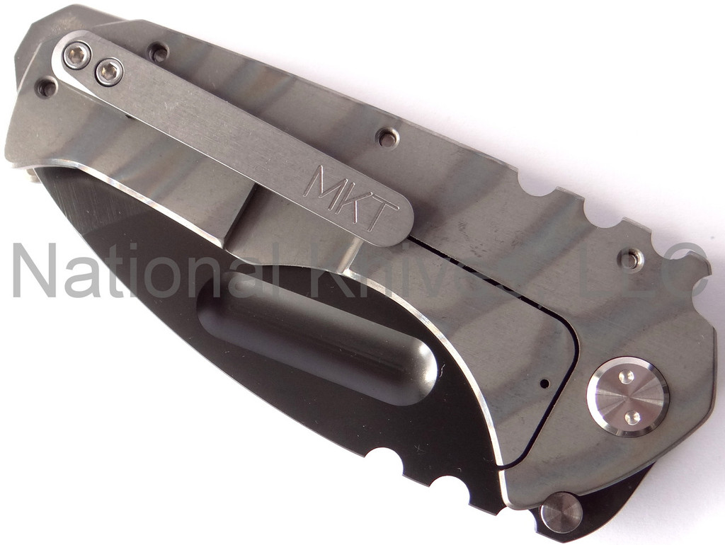 Medford Knives Praetorian folding knife with thumb groove - shown closed lock side.  Black Oxide D2 steel plain edge blade.  Flame anodized titanium handle.  Model MK12DPT-03FL.
For reference only.