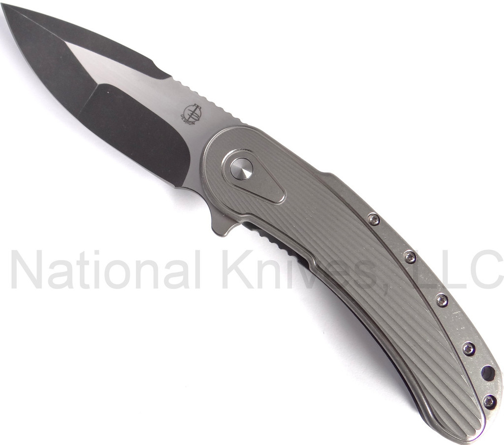 Todd Begg Knives Bodega 2.0 folding knife with flipper tab - shown open presentation side.  2-tone N690 stainless steel plain edge blade.  Gray titanium handle.
For reference only.