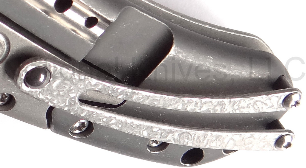 Todd Begg Knives Bodega 2.0 folding knife with flipper tab - shown close up of pocket clip.  2-tone N690 stainless steel plain edge blade.  Gray titanium handle.
For reference only.