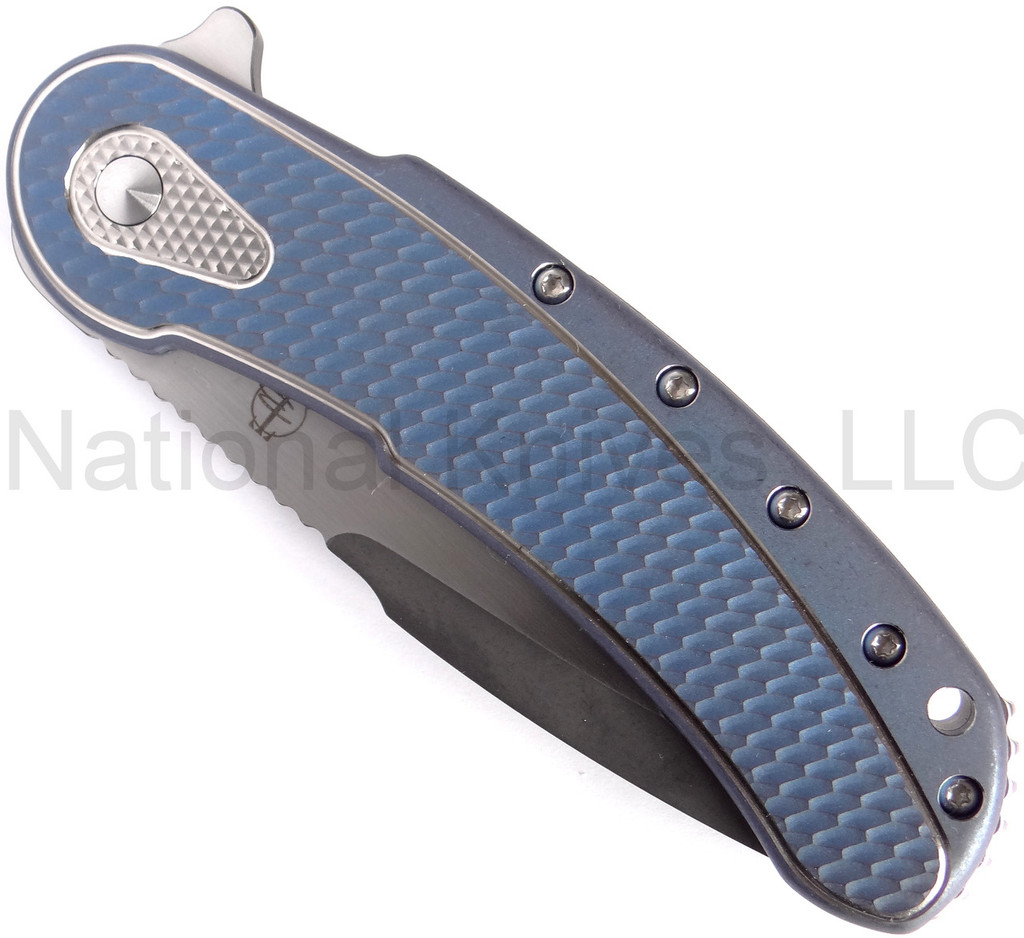 Todd Begg Knives Bodega 2.0 folding knife with flipper tab - shown closed presentation side.  2-tone N690 stainless steel plain edge blade.  Blue titanium handle.
For reference only.