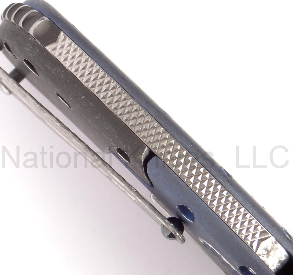 Todd Begg Knives Bodega 2.0 folding knife with flipper tab - shown close up of back spacer.  2-tone N690 stainless steel plain edge blade.  Blue titanium handle.
For reference only.