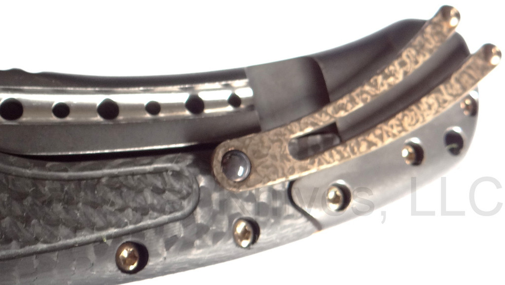 Todd Begg Knives Bodega Field Grade folding knife with flipper tab - shown close up of pocket clip.  2-tone N690 stainless steel plain edge blade.  Carbon fiber handle.
For reference only.