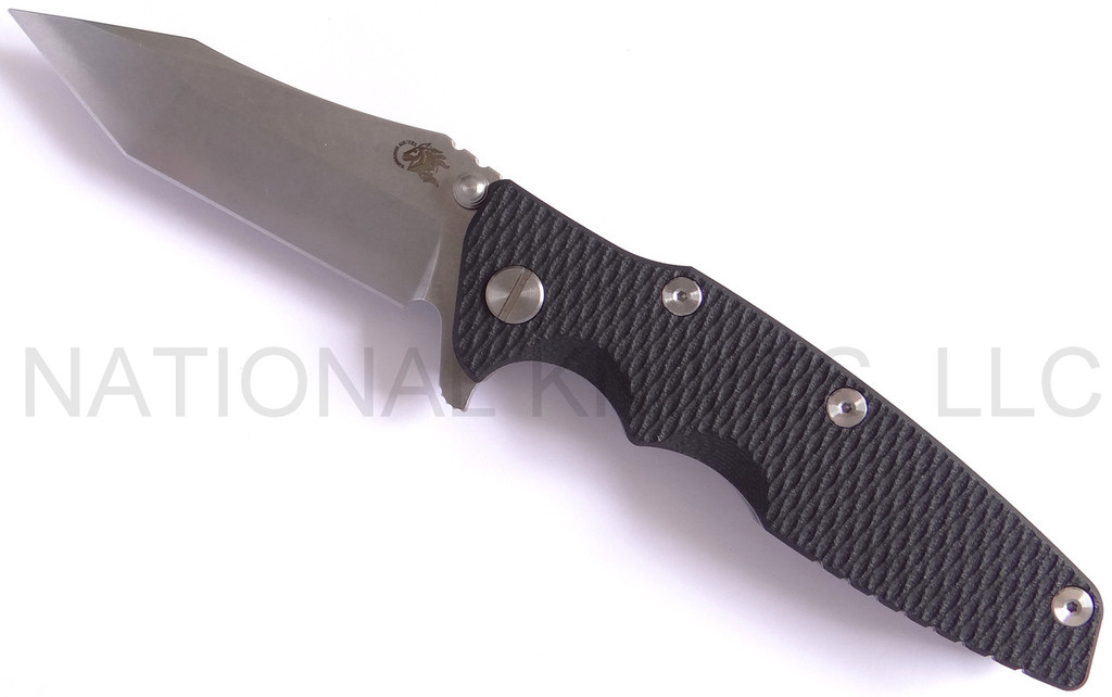 Rick Hinderer Knives Eklipse Tanto folding knife with thumb stud and flipper tab - shown open presentation side.  Stonewash S35VN stainless steel plain edge blade.  Black G-10 handle with Working Finish lock side.  Model K40040TD00.
For reference only.