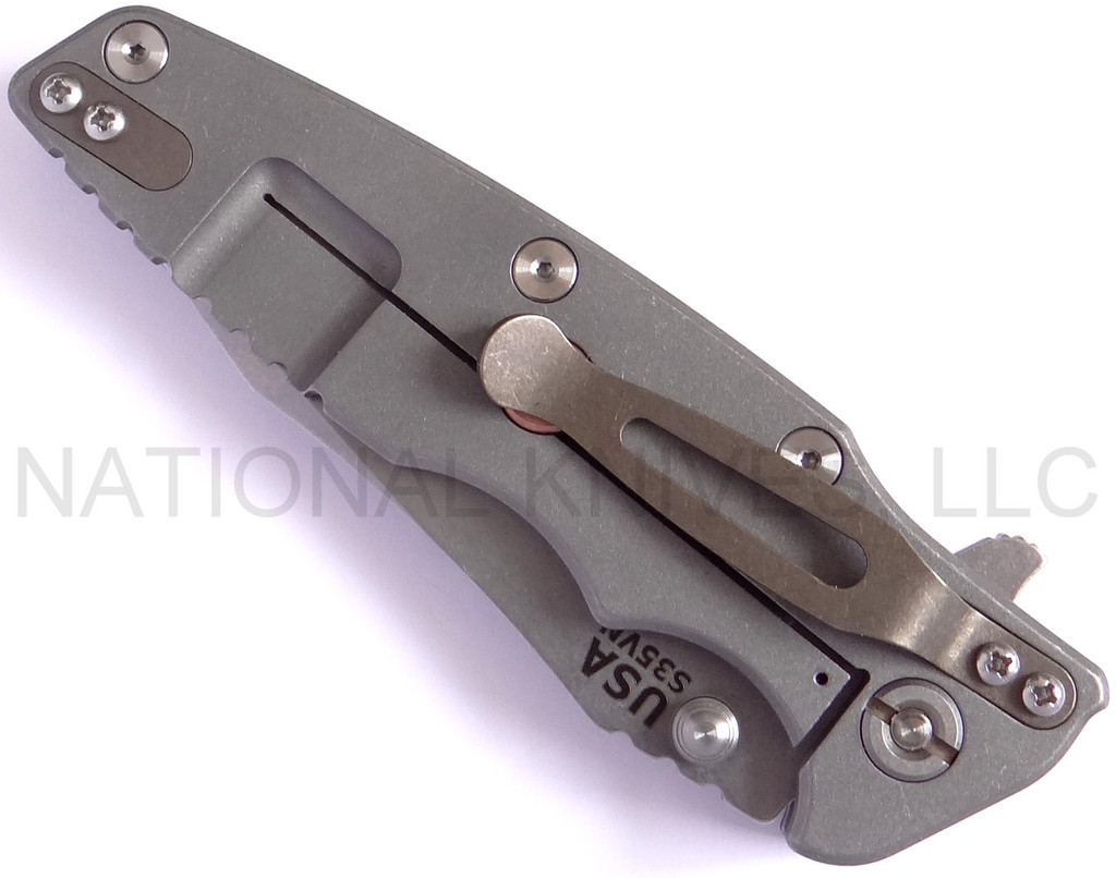 Rick Hinderer Knives Eklipse Tanto folding knife with thumb stud and flipper tab - shown closed lock side.  Stonewash S35VN stainless steel plain edge blade.  Black G-10 handle with Working Finish lock side.  Model K40040TD00.
For reference only.