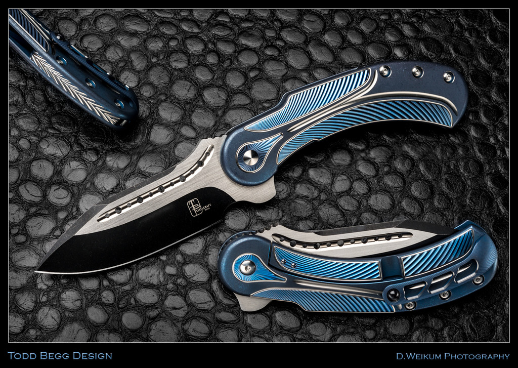 Todd Begg Knives Steelcraft Series Field Marshall folding knife - shown open presentation side, closed pocket clip side, and close up of back spacer.  2-Tone S35VN stainless steel plain edge blade.  Blue and Silver titanium handle.  Model FM232.
For reference only.