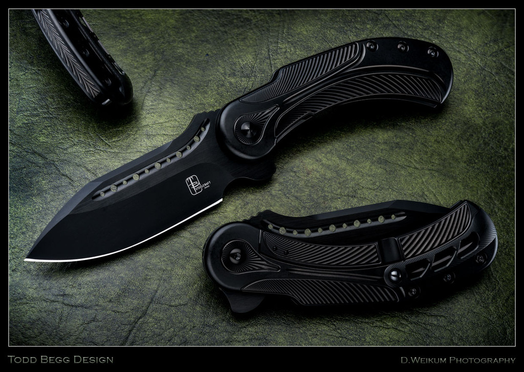 Todd Begg Knives Steelcraft Series Field Marshall folding knife - shown open presentation side.  2-tone black S35VN stainless steel plain edge blade.  Black titanium handle.  Model FM211.
For reference only.