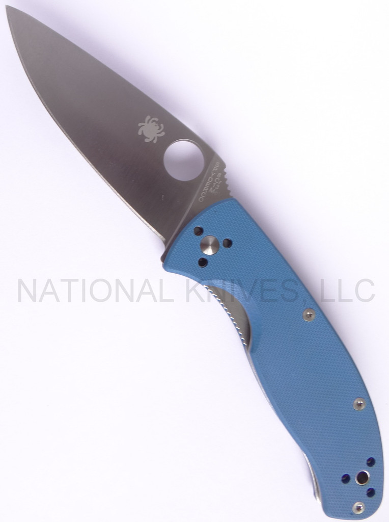Spyderco Tenacious JB Outman Exclusive folding knife with thumb hole - shown open presentation side.  Satin 8Cr13MoV stainless steel plain edge blade.  Blue G-10 handle.  C122GPBL.
For reference only.