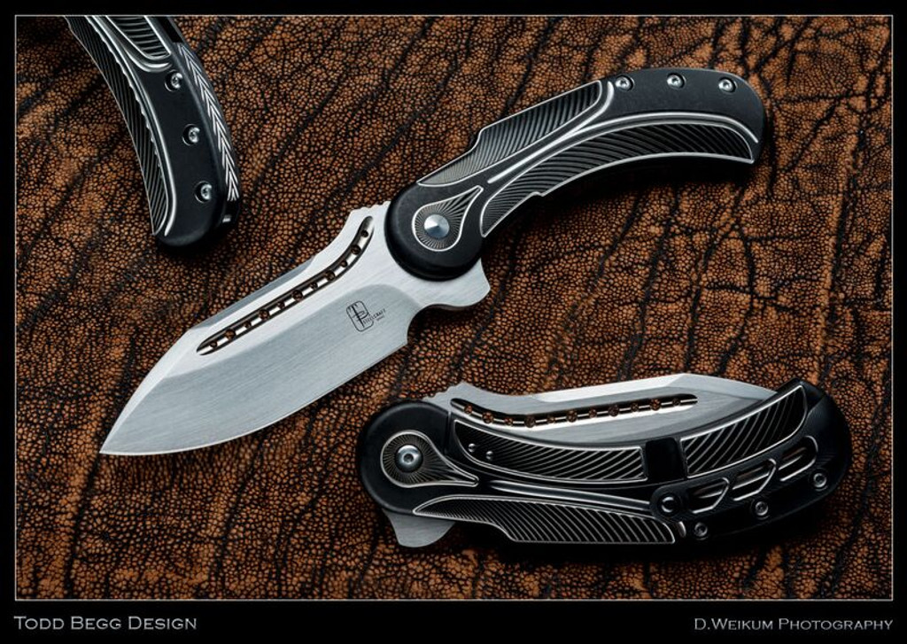 Todd Begg Knives Steelcraft Series Field Marshall folding knife - shown open presentation side, closed pocket clip side, and close up of back spacer.  Hand satin S35VN stainless steel plain edge blade.  Black and Silver titanium handle.  Model FM223.
For reference only.