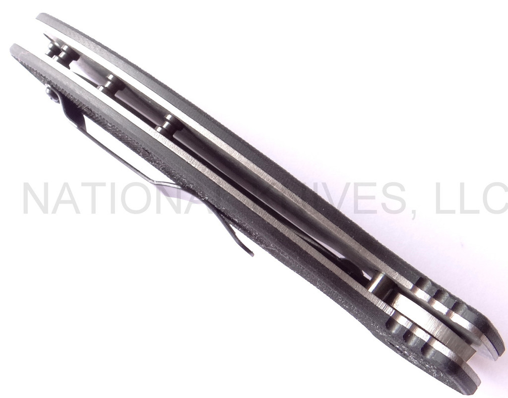 Emerson Knives Aftershock SF folding knife with thumb disk and Emerson Wave - shown closed top view.   Stonewashed 154CM stainless steel plain edge blade.  Black G-10 handle.  Model AFTERSHOCK-SW.
For reference only.