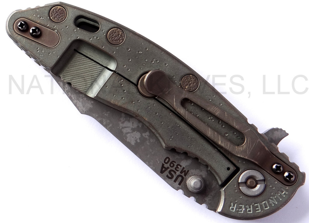 Rick Hinderer Knives Battlefield Pick Up XM-18 3.5" Harpoon Spanto folding knife with thumb stud and flipper tab - shown closed lock side.  M390 stainless steel plain edge blade.  OD green G-10 handle with titanium lock side.  Model K25520SP00.
For reference only.