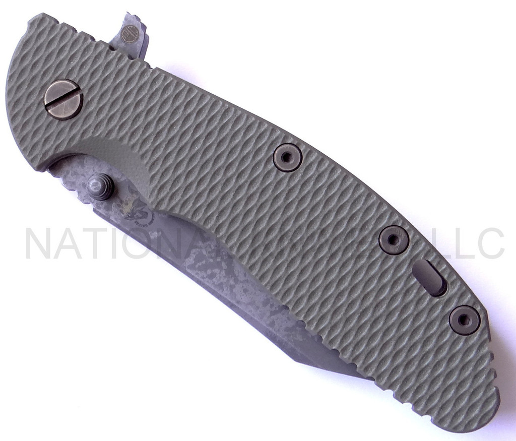 Rick Hinderer Knives Battlefield Pickup XM-24 Wharncliffe folding knife with thumb stud and flipper tab - shown closed presentation side.  M390 stainless steel plain edge blade.  OD green G-10 handle with titanium lock side.  Model K30230SPBF.
For reference only.