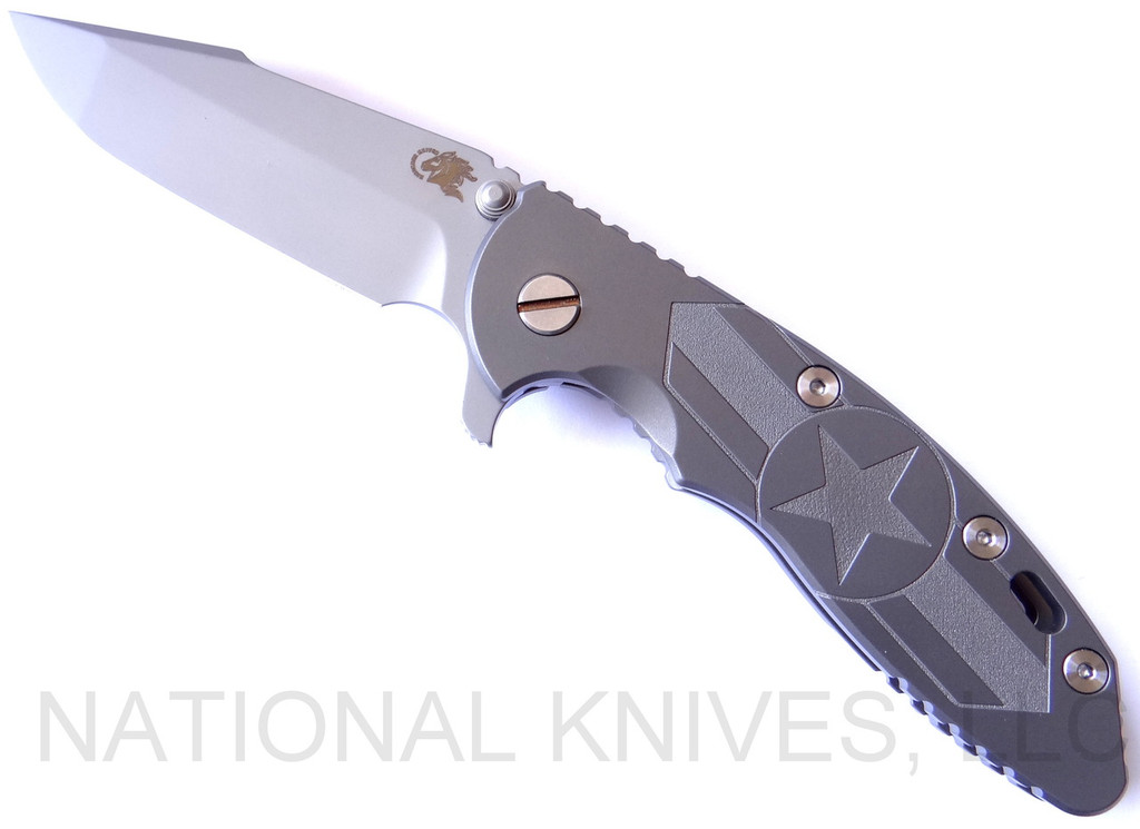 Rick Hinderer Knives Stars and Bars XM-18 3.5" Harpoon Spanto folding knife with thumb stud and flipper tab - shown open presentation side.  Bead Blast 20CV stainless steel plain edge blade.  Bead Blast titanium handle with Bead Blast lock side.  Model K25520SP00.
For reference only.