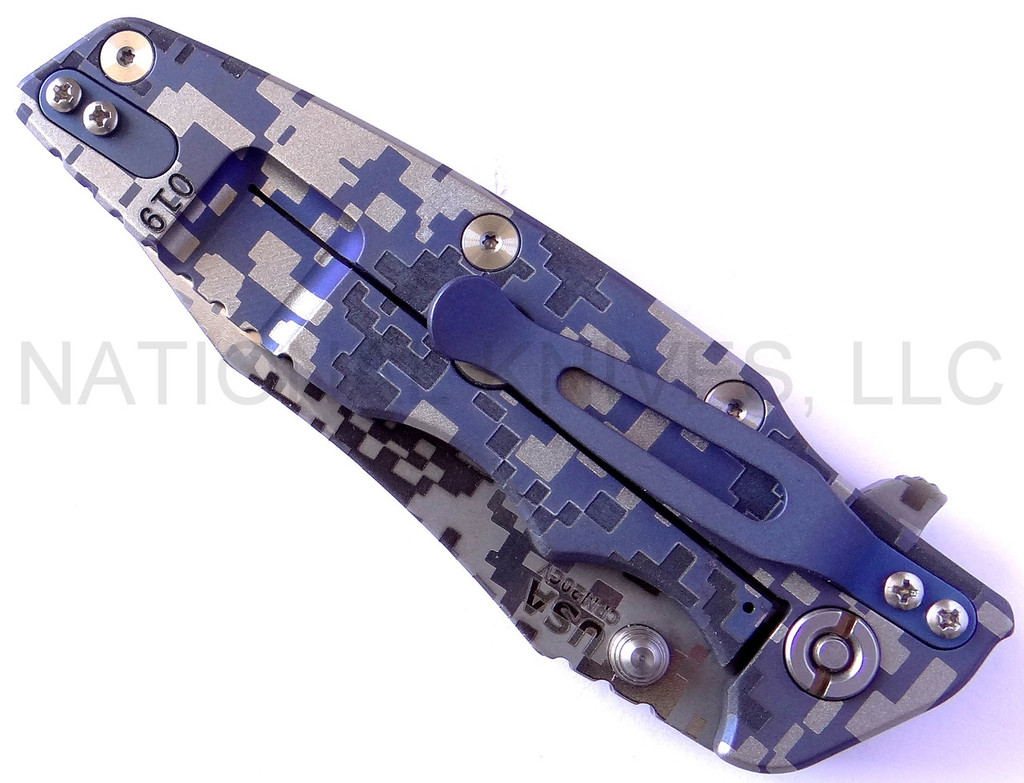 Rick Hinderer Knives Digi Camo Edition Eklipse Harpoon Tanto folding knife with thumb stud and flipper tab - shown closed lock side.  Working Finish 20CV stainless steel plain edge blade.  Blue - black G-10 handle with Battle Blue lock side.  Model K40042S000.
For reference only.