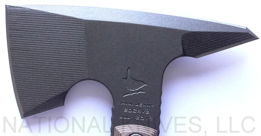 RMJ Tactical Mini Jenny tomahawk - close up of head out of sheath reverse shown.  Tungsten Cerakote 80CRV2 steel plain edge head.  Hyena Brown G-10 handle.  
For reference only.