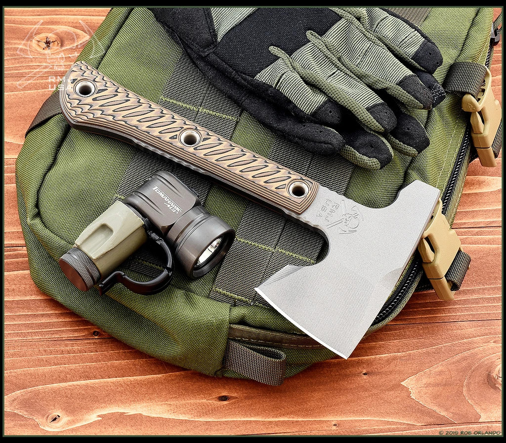 RMJ Tactical Mini Jenny Hammer Pole tomahawk - shown out of sheath obverse.  Tungsten Cerakote 80CRV2 steel plain edge head.  Hyena Brown G-10 handle.  
For reference only.