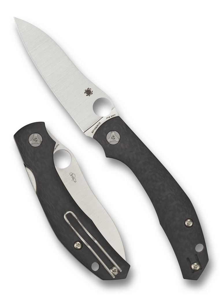 Spyderco Kapara folding knife with thumb hole and flipper - shown open presentation side and closed pocket clip side.  Satin S30V stainless steel plain edge blade.  Black carbon fiber handle.  Model C241CFP.