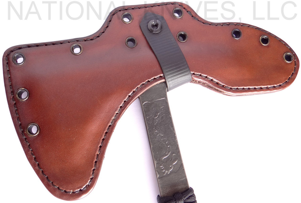 RMJ Tactical Custom Range 37 Kestrel tomahawk - shown close up of head in sheath reverse.  80CRV2 steel plain edge head.  Black cord-wrapped handle.
For reference only.