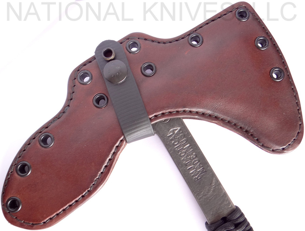 RMJ Tactical Custom Range 37 Kestrel tomahawk - shown close up of head in sheath obverse.  80CRV2 steel plain edge head.  Black cord-wrapped handle.
For reference only.