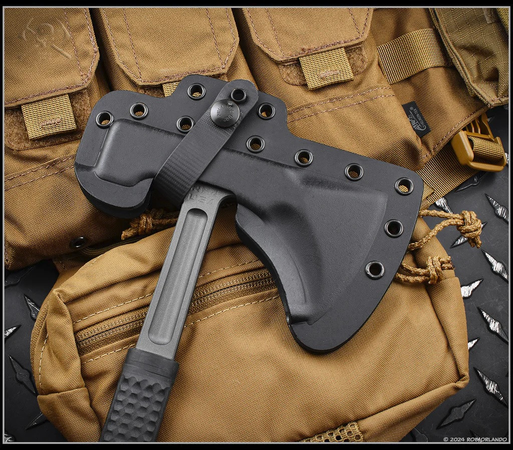 RMJ Tactical L13 Loggerhead tomahawk - shown close up of head in sheath obverse.  Tungsten Cerakote 80CRV2 plain edge head.  Black rubber handle.  Model T-L13-TU-BK.