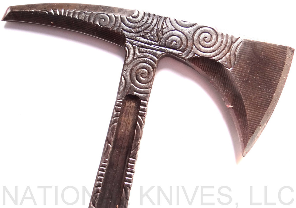 RMJ Tactical Custom Valhalla Kestrel Tomahawk with Triskelle pattern - close up of head reverse.  80CRV2 steel plain edge head.  Brown Micarta handle scales.  
For reference only.