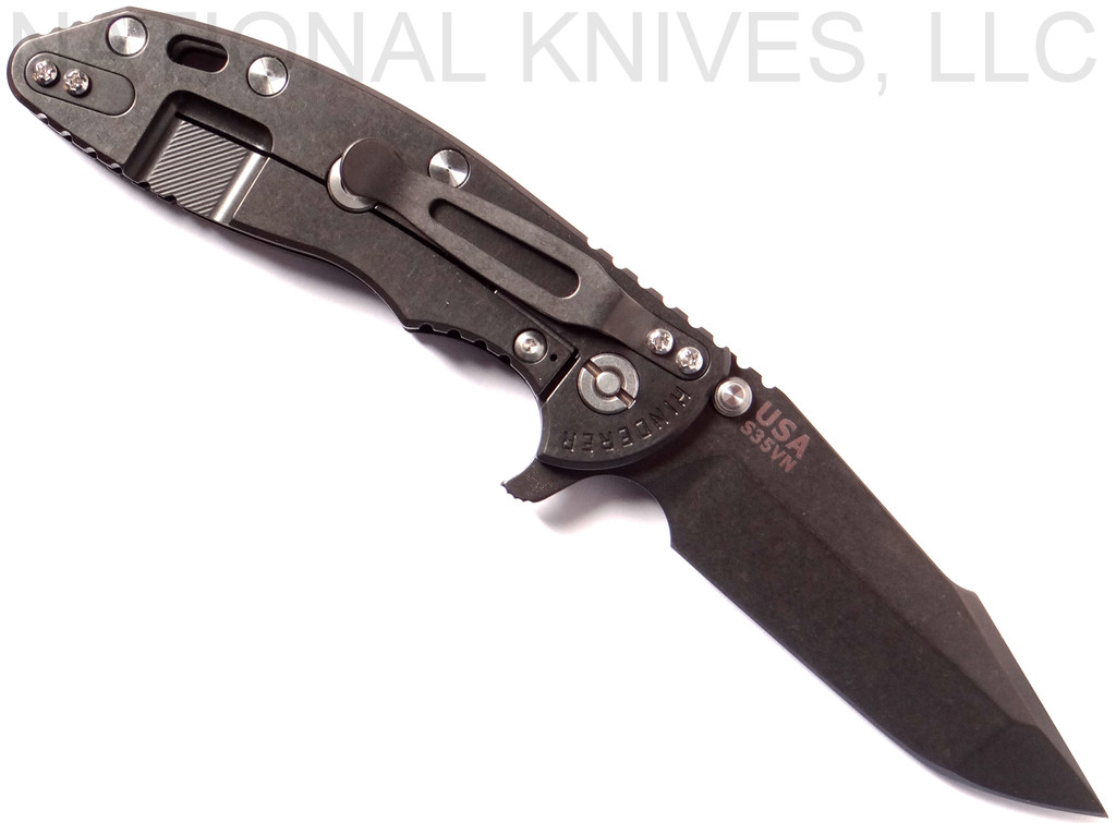 Rick Hinderer Knives XM-18 3.5" Harpoon Spanto folding knife with thumb stud and flipper tab - shown open lock side.  Black stonewash S35VN stainless steel plain edge blade.  Black G-10 handle with stonewash black lock side.  Model K2552SGD00.