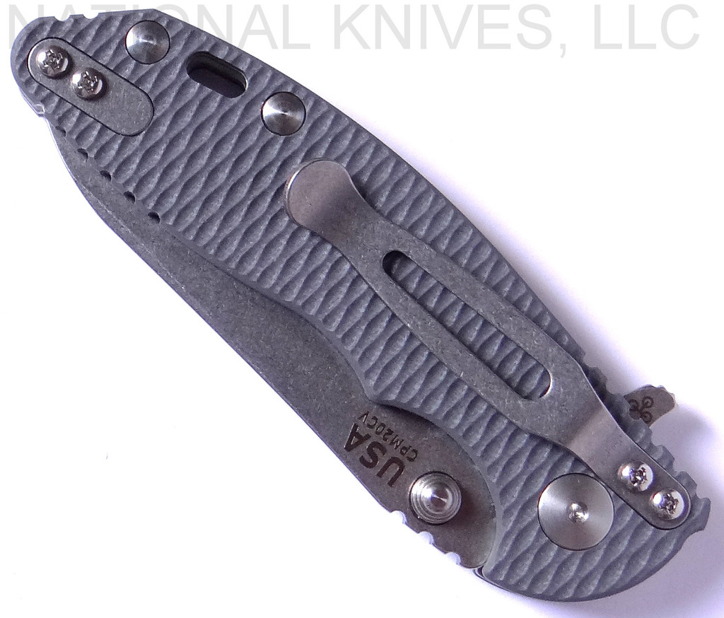 Rick Hinderer Knives Skinny XM-18 3.0" Sheepsfoot folding knife with thumb stud and flipper tab - shown closed pocket clip side.  Stonewash 20CV stainless steel plain edge blade.  Grey G-10 handle with stonewash lock.  Model K1101SSGS00.