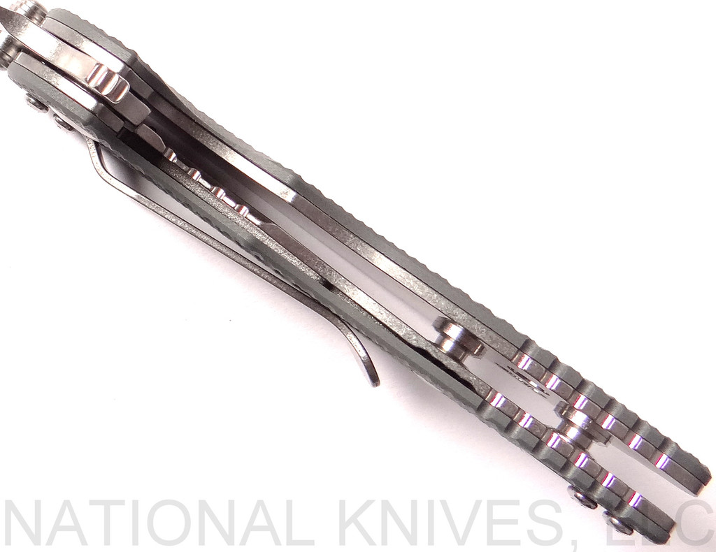 Rick Hinderer Knives Skinny XM-18 3.0" Sheepsfoot folding knife with thumb stud and flipper tab - shown open close up of lock.  Stonewash 20CV stainless steel plain edge blade.  Grey G-10 handle with stonewash lock.  Model K1101SSGS00.