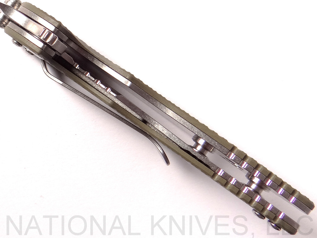 Rick Hinderer Knives Skinny XM-18 3.0" Sheepsfoot folding knife with thumb stud and flipper tab - shown open close up of lock.  Stonewash 20CV stainless steel plain edge blade.  OD green G-10 handle with stonewash lock.  Model K1101SSGS00.