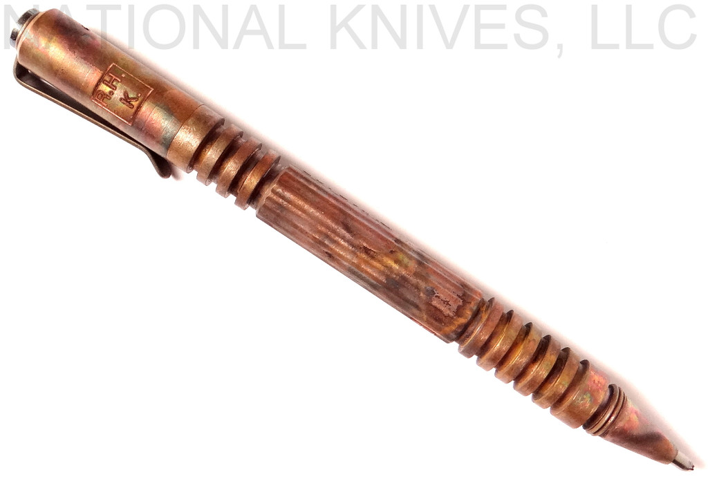 Rick Hinderer Knives Investigator ink pen - shown with cap on.  Battlefield Pick Up copper construction.  Model P5801006BF.
For reference only.