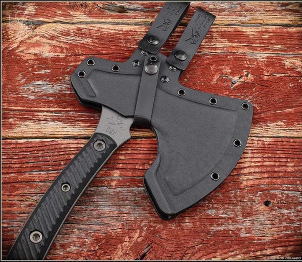 RMJ Tactical Berserker Axe - shown in sheath obverse.  Tungsten Cerakote 80CrV2 steel blade.  Black G-10 handle scales.  