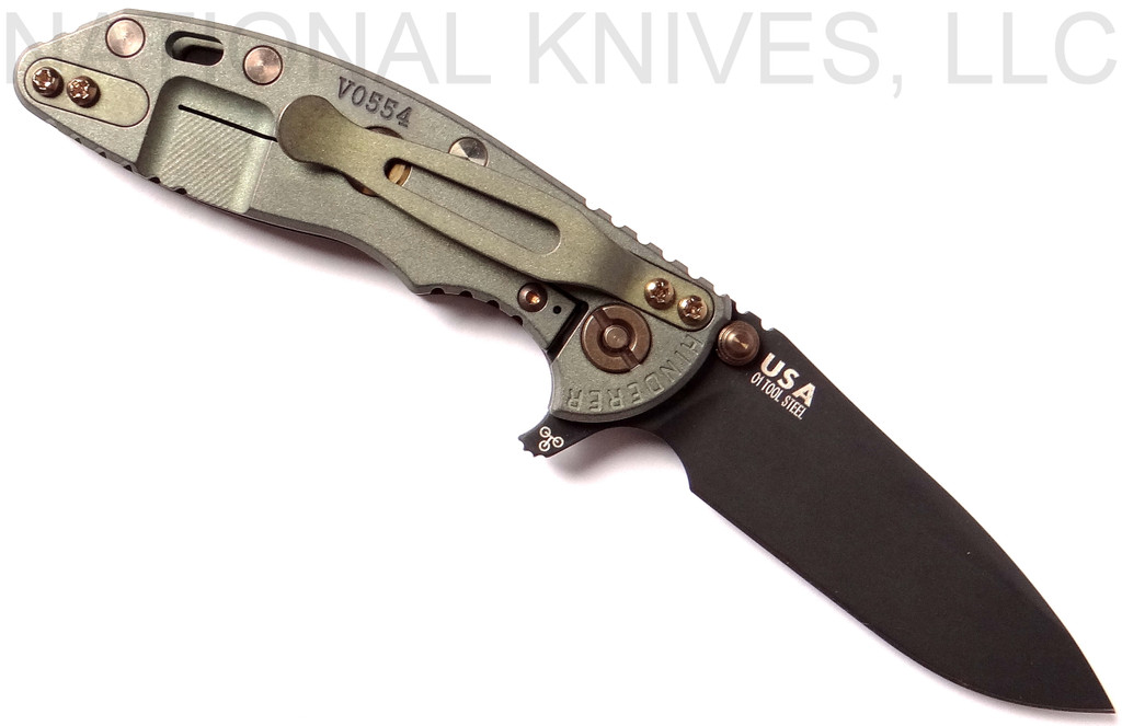 Rick Hinderer Knives Vintage Series XM-18 3.0" Spear Point folding knife with thumb studs and flipper tab - shown open lock side.  Black O-1 steel plain edge blade.  Smooth Walnut handle with Battle Green lock side.  Model K1081S0VT-SM.
For reference only.