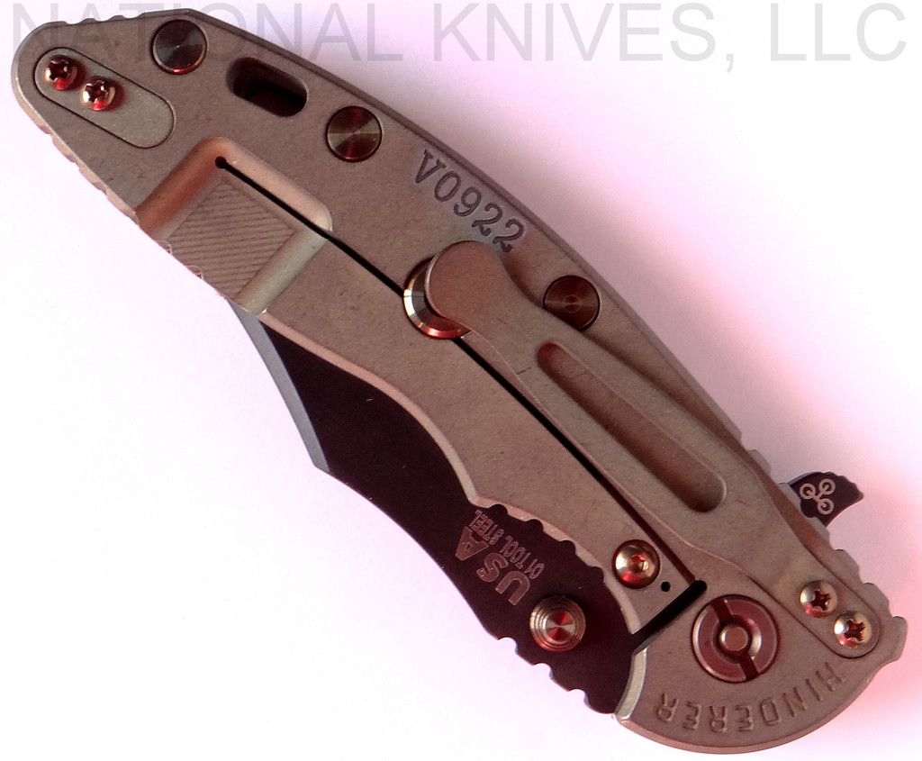 Rick Hinderer Knives Vintage Series XM-18 3.5" Bowie folding knife with thumb stud and flipper tab - shown closed lock side.  Black O-1 steel plain edge blade.  Smooth Walnut handle with Battle Green titanium lock side.  Model K2032S0VT.
For reference only.
