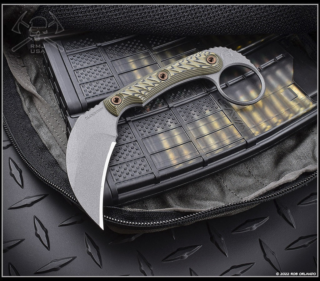 RMJ Tactical Korbin Karambit fixed blade knife - shown out of sheath obverse.  Tungsten Cerakote Nitro-V stainless steel plain edge blade.  Dirty Olive G-10 handle.  Model K-KO-TU-DO.