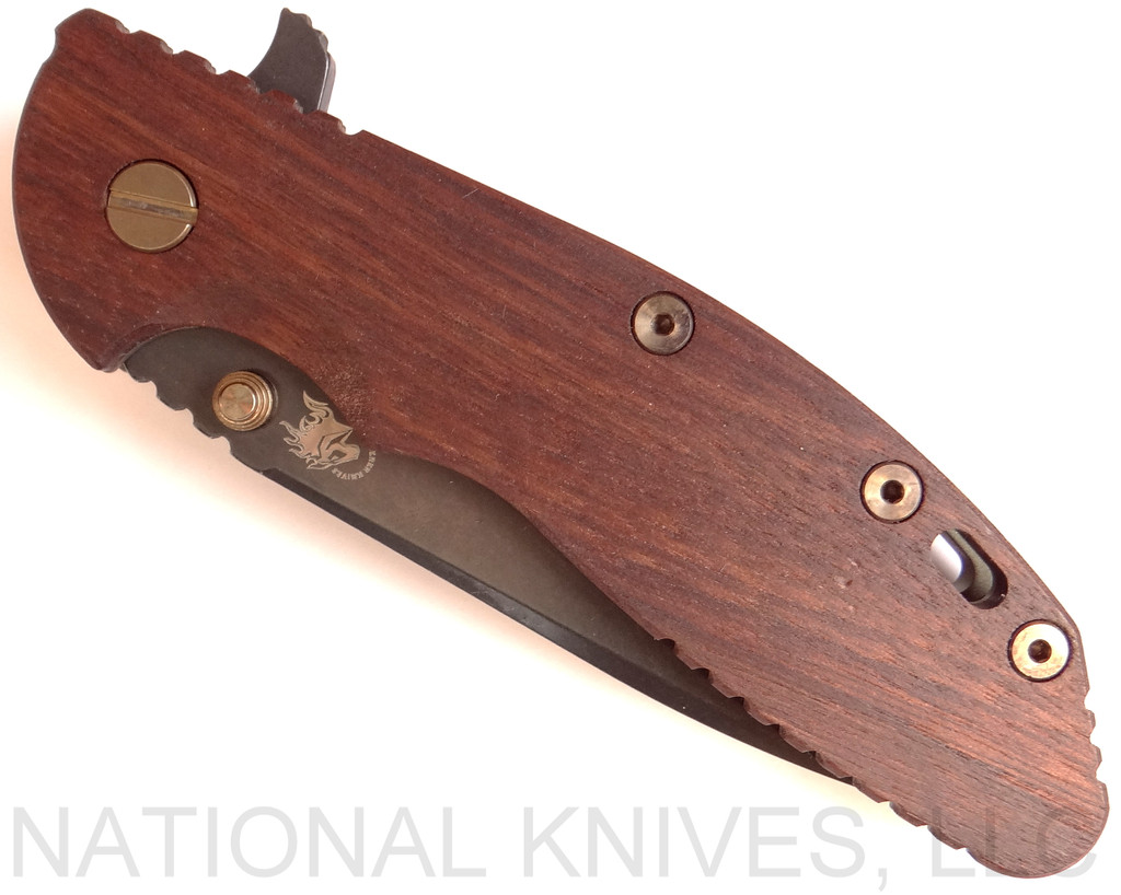 Rick Hinderer Knives Vintage Series XM-24 Spear Point folding knife with thumb stud and flipper tab - shown closed presentation side.  Black O-1 steel plain edge blade.  Smooth Walnut handle with Battle Green lock side.  Model K3083S0VT00.
For reference only.