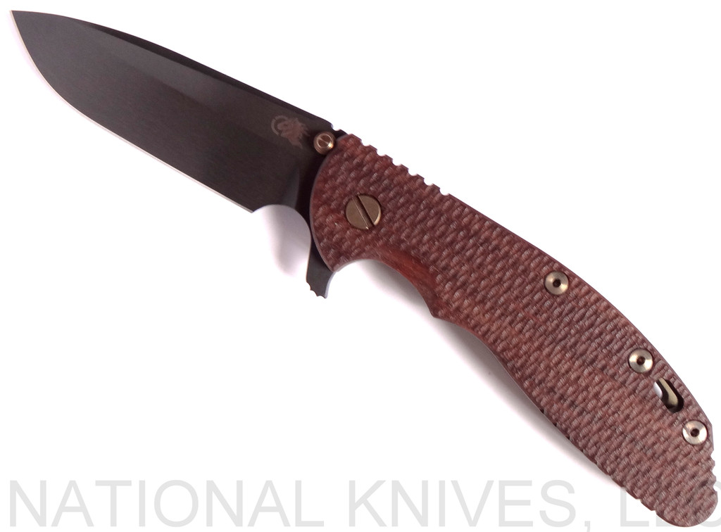 Rick Hinderer Knives Vintage Series XM-24 Spear Point folding knife with thumb stud and flipper tab - shown open presentation side.  Black O-1 steel plain edge blade.  Textured Walnut handle with Battle Green lock side.  Model K3083S0VT00.
For reference only.