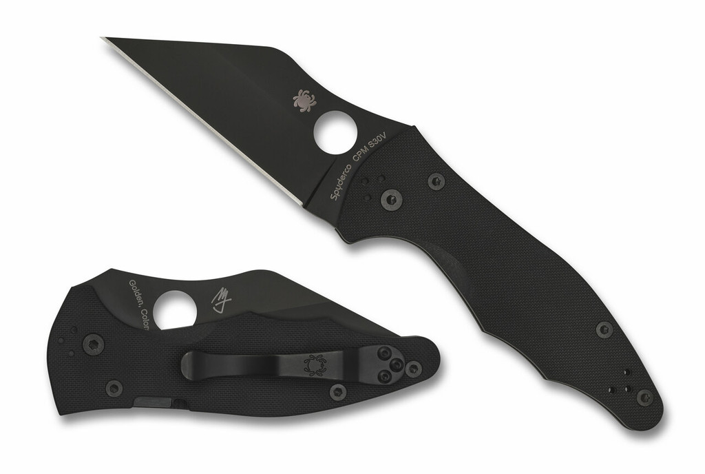 Spyderco Yojimbo 2 folding knife with thumb hole - shown open presentation side and closed pocket clip side.  Black S30V stainless steel plain edge blade.  Black G-10 handle. Model C85GPBBK2.