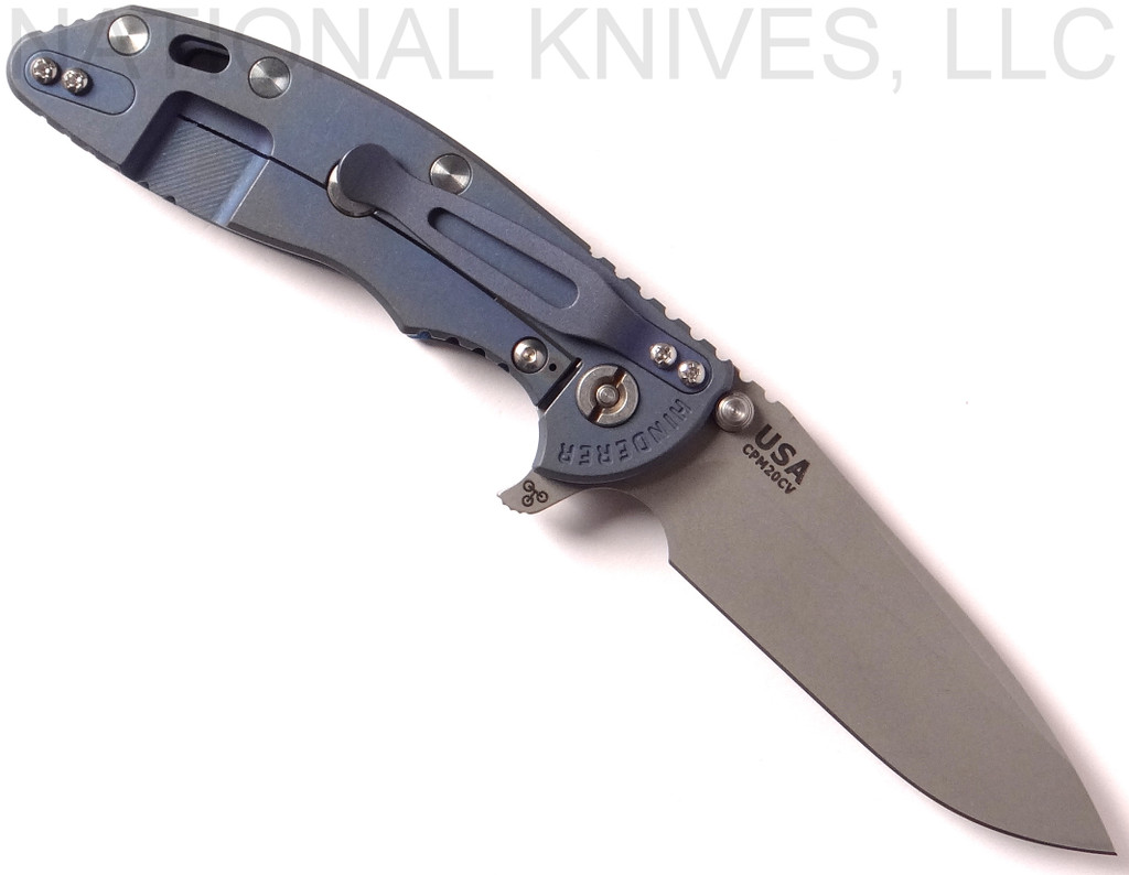Rick Hinderer Knives XM-18 3.5" Spear Point folding knife with thumb stud and flipper tab - shown open lock side.  Working Finish 20CV stainless steel plain edge blade.  Blue - black G-10 handle with Battle Blue lock side.  Model K2082SGW00.
