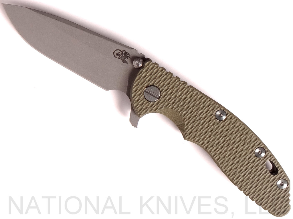 Rick Hinderer Knives XM-18 3.5" Spear Point folding knife with thumb stud and flipper tab - shown open presentation side.  Working Finish 20CV stainless steel plain edge blade.  OD green G-10 handle with Battle Bronze lock side.  Model K2082SGW00.