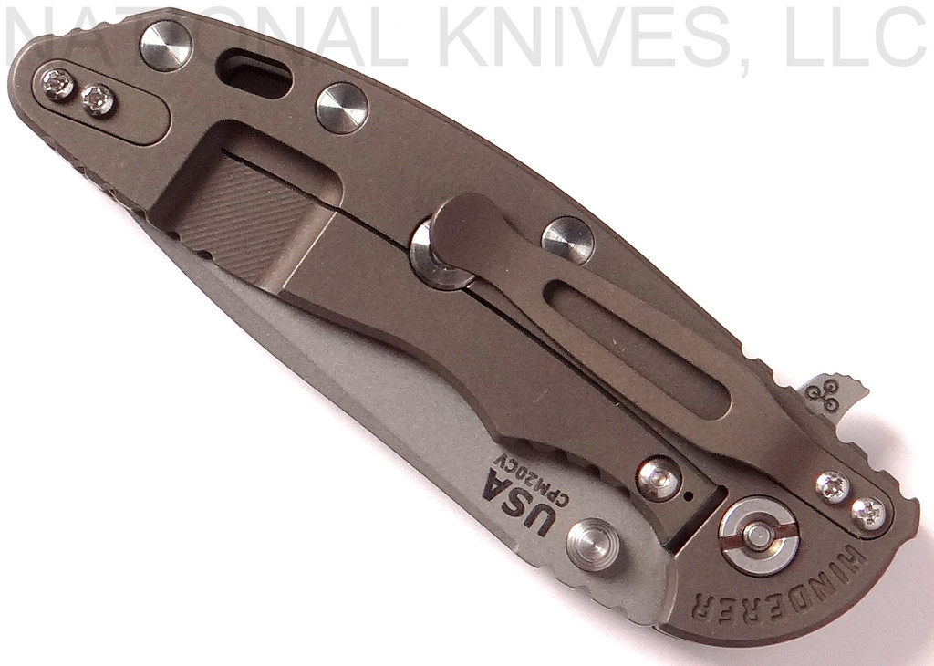 Rick Hinderer Knives XM-18 3.5" Spear Point folding knife with thumb stud and flipper tab - shown closed lock side.  Working Finish 20CV stainless steel plain edge blade.  OD green G-10 handle with Battle Bronze lock side.  Model K2082SGW00.