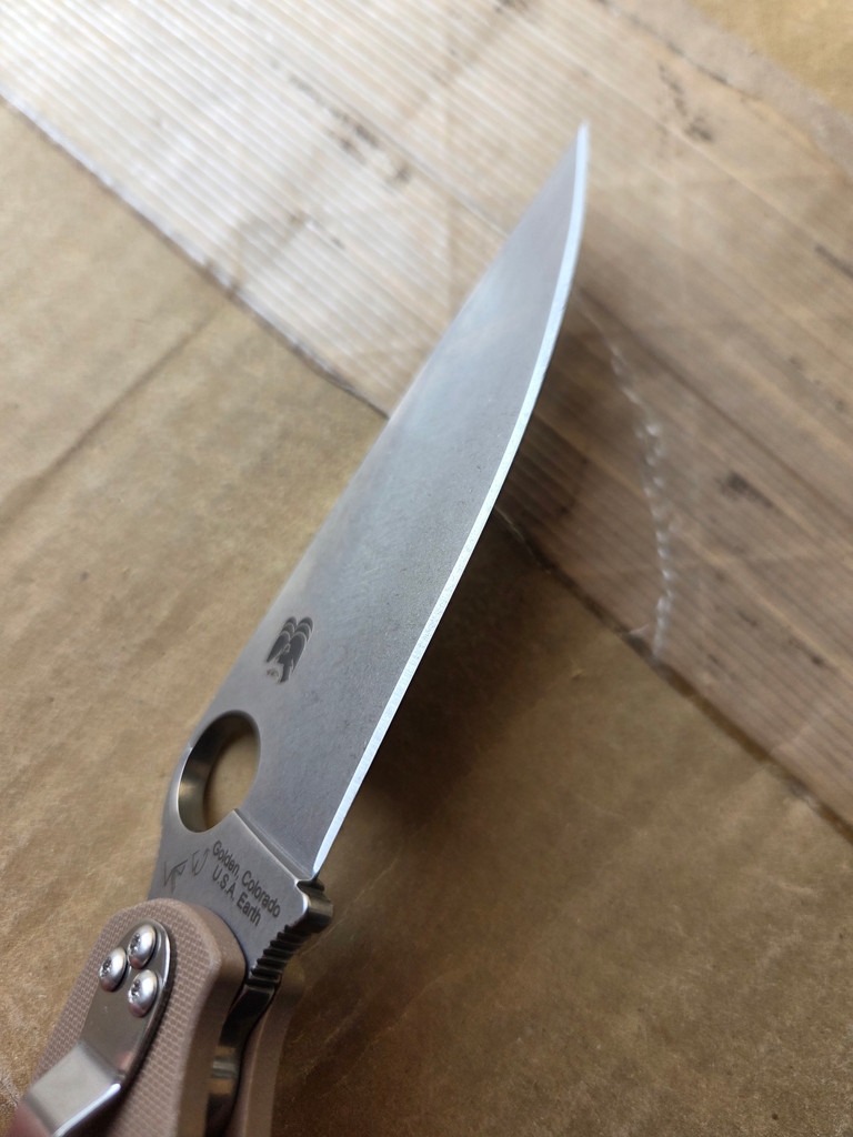 Used Spyderco Military 2 Sprint Run folding knife with thumb hole - close up of pocket clip side blade.  Stonewash 15V steel plain edge blade.  Brown G-10 handle.  Model C36GPBN15V2.