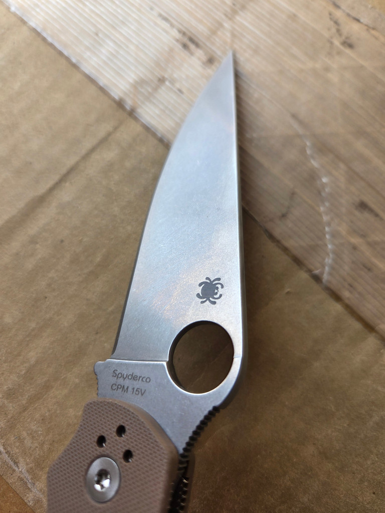 Used Spyderco Military 2 Sprint Run folding knife with thumb hole - close up of presentation side blade.  Stonewash 15V steel plain edge blade.  Brown G-10 handle.  Model C36GPBN15V2.