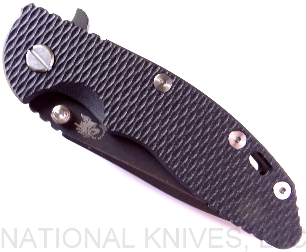 Rick Hinderer Knives XM-18 3.5" Spanto folding knife with thumb stud and flipper tab - shown closed presentation side.  Battle Black 20CV stainless steel plain edge blade.  Black G-10 handle with Battle Black lock side.  Model K2002SGDSW.