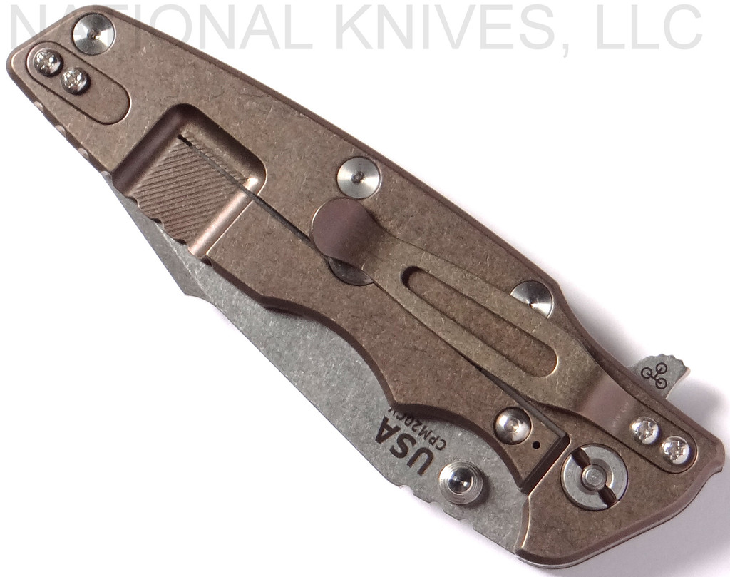 Rick Hinderer Knives Eklipse Harpoon Tanto folding knife with thumb stud and flipper tab - shown closed lock side.  Stonewash 20CV stainless steel plain edge blade.  Black G-10 handle with stonewash bronze lock side.  Model K4054SGS00.