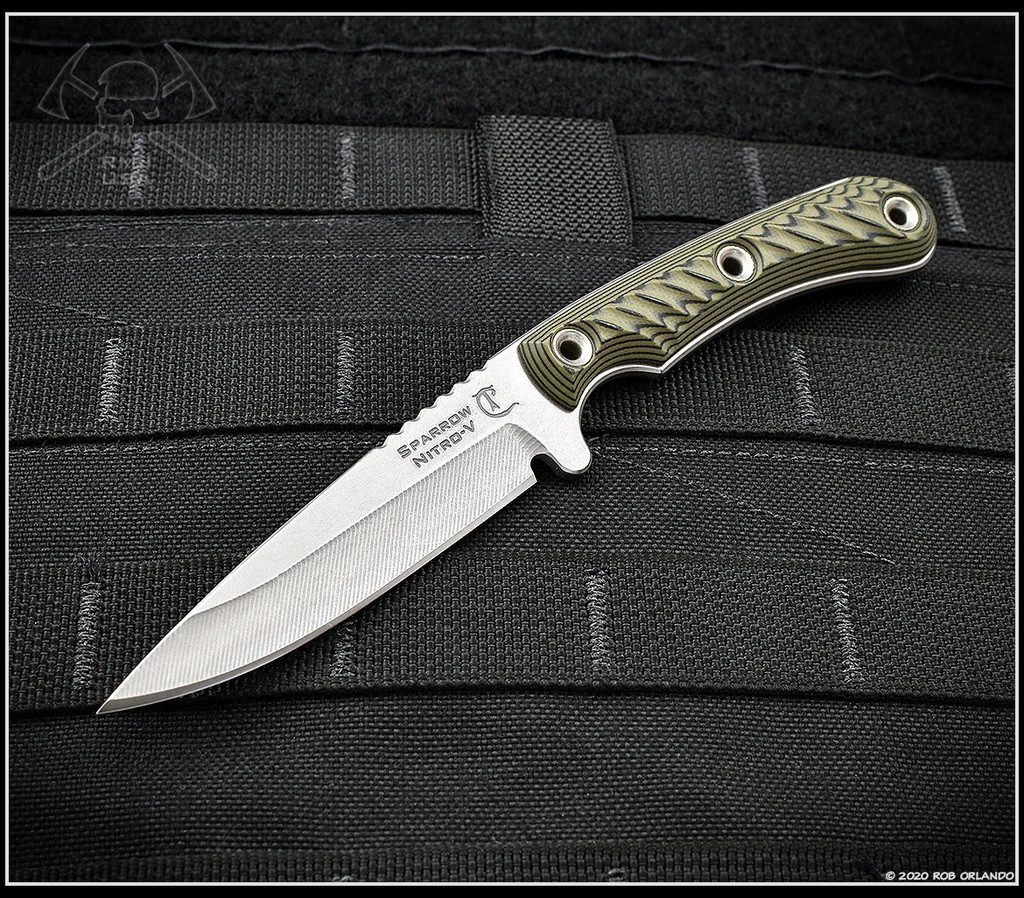 RMJ Tactical Sparrow fixed blade knife - shown out of sheath reverse.  Stonewash Nitro-V stainless steel plain edge blade.  Dirty Olive G-10 handle.
For reference only.