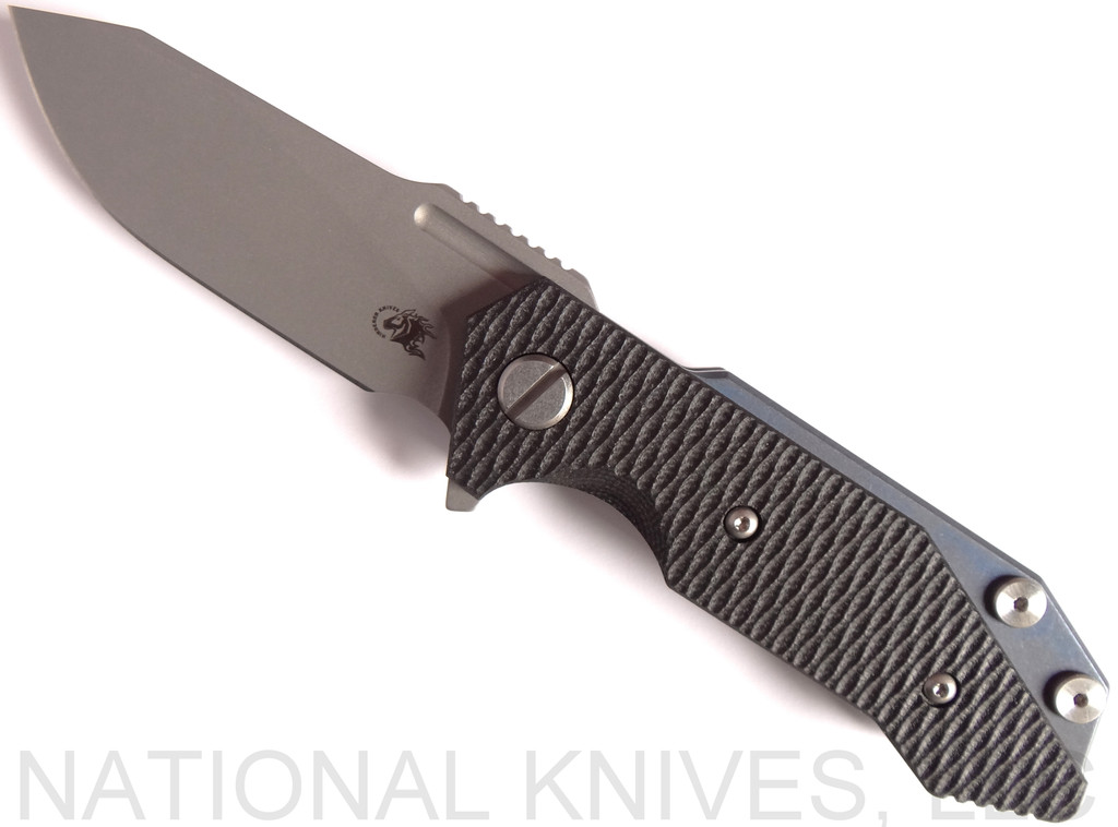 Rick Hinderer Knives Half Track Slicer folding knife with flipper tab - shown open presentation side.  Stonewash 20CV stainless steel plain edge blade.  Black G-10 handle with Battle Blue titanium lock side.  Model K2009SGS00.