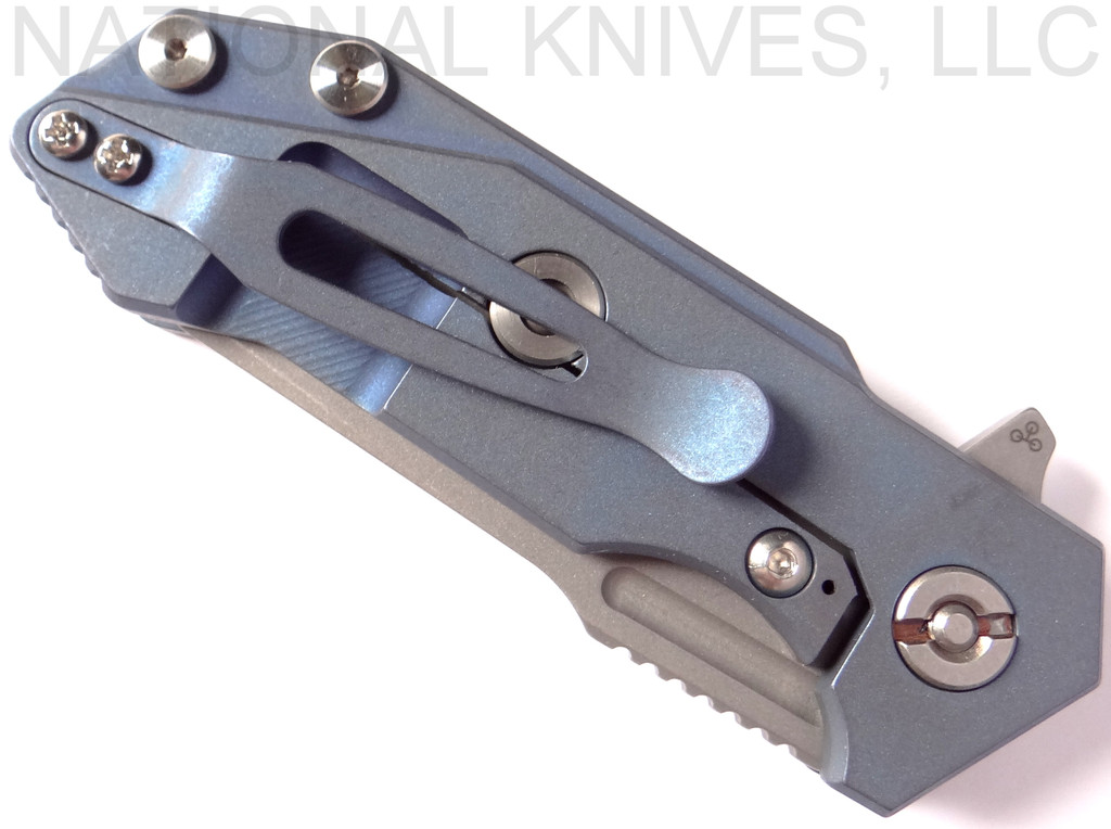 Rick Hinderer Knives Half Track Slicer folding knife with flipper tab - shown closed lock side.  Stonewash 20CV stainless steel plain edge blade.  Black G-10 handle with Battle Blue titanium lock side.  Model K2009SGS00.