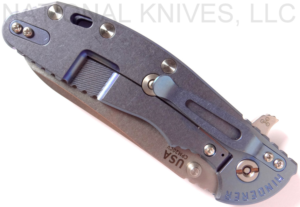 Rick Hinderer Knives XM-24 Sheepsfoot folding knife with thumb stud and flipper tab - shown closed lock side.  Stonewash 20CV stainless steel plain edge blade.  Blue - black G-10 handle with stonewash blue lock side.  Model K3073SGS00.
