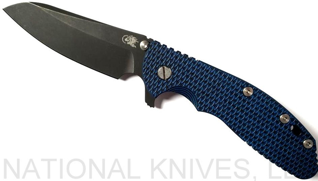 Rick Hinderer Knives XM-24 Sheepsfoot folding knife with thumb stud and flipper tab - shown open presentation side.  Battle Black 20CV stainless steel plain edge blade.  Blue - black G-10 handle with Battle Black lock side.  Model K3073SGD00.
