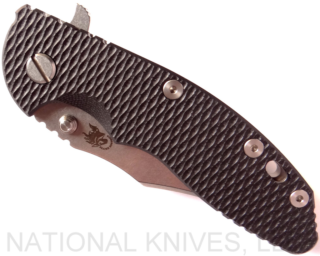 Rick Hinderer Knives XM-18 3.5" Bowie folding knife with thumb stud and flipper tab - shown closed presentation side.  Stonewash 20CV stainless steel plain edge blade.  Black G-10 handle with stonewash titanium lock side.  Model K2032SGS00.