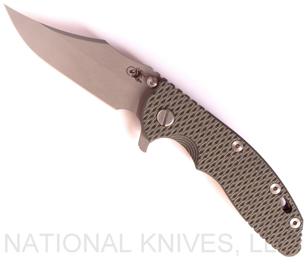 Rick Hinderer Knives XM-18 3.5" Bowie folding knife with thumb stud and flipper tab - shown open presentation side.  Working Finish 20CV stainless steel plain edge blade.  OD green - black G-10 handle with Battle Bronze titanium lock side.  Model K2032SGW00.
